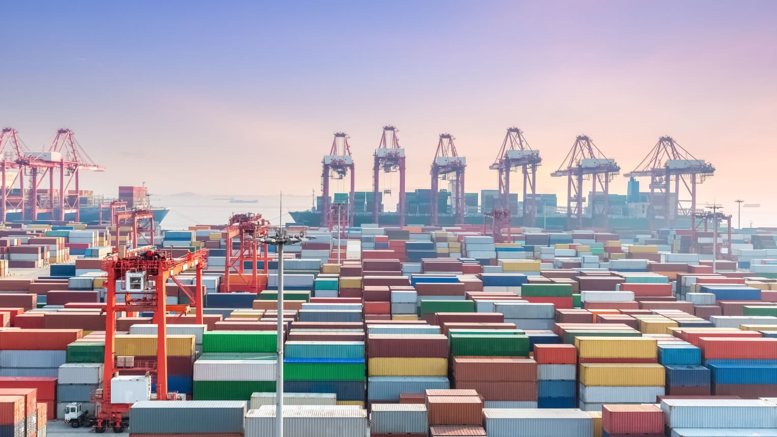 Global shipping containers at a busy commercial port representing reliable worldwide logistics