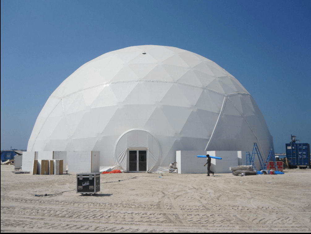 Packaged DX cooling unit deployed beside a large outdoor event tent