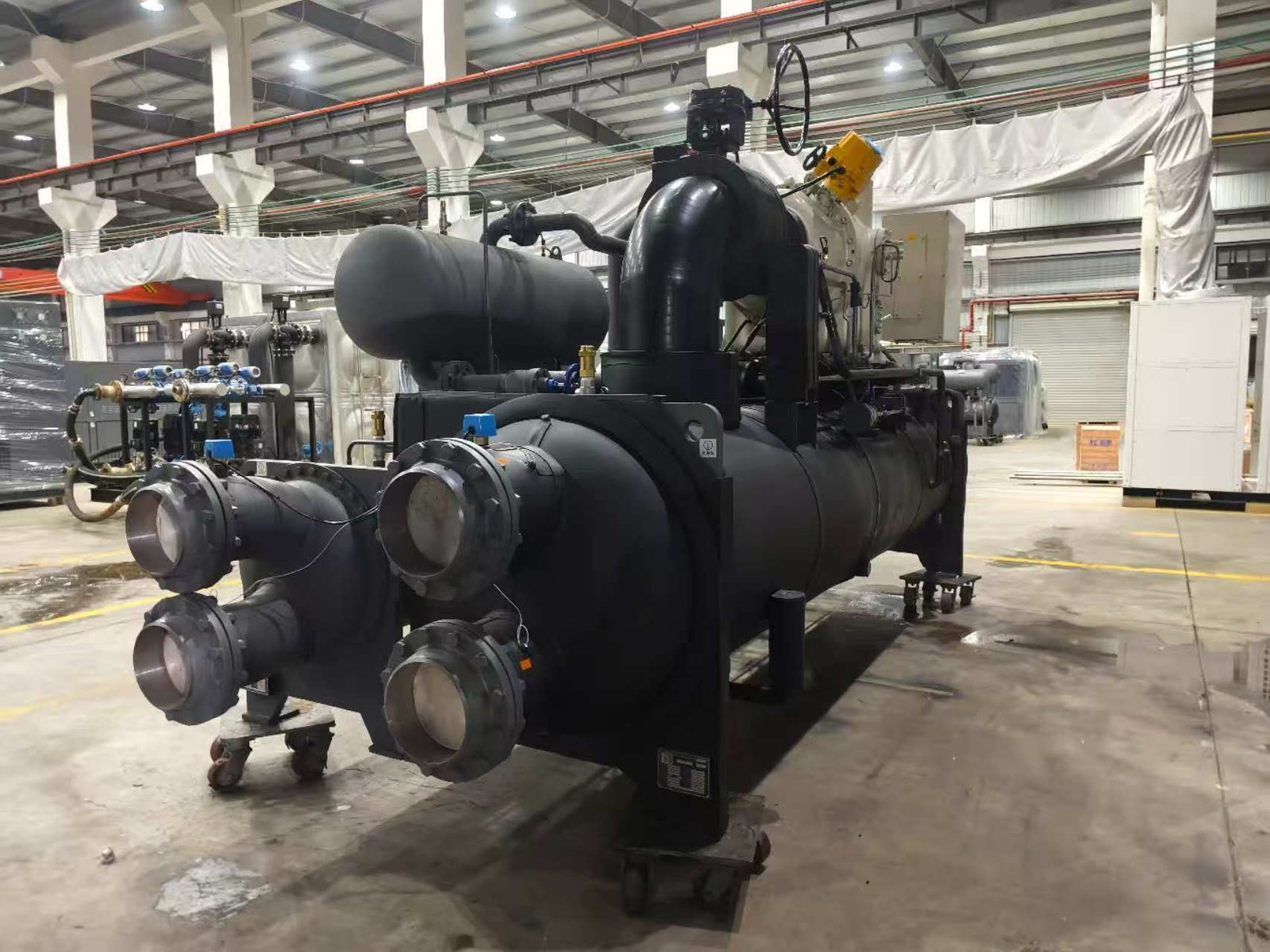 Industrial water-cooled chiller system with blue pipes in a large cooling facility